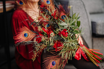 Original bouquet decorated with red peacock feathers.