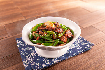 Spicy Stir-fried beef with wild pepper served dish isolated on wooden table top view of Hong Kong food