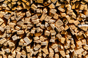 Photography on theme big wall of stacked oak tree logs in cracks
