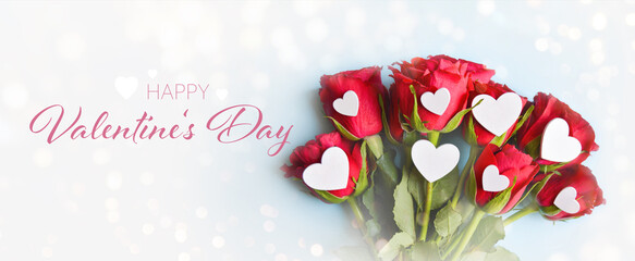 Fototapeta na wymiar Happy Valentine's Day greeting card - Bouquet of red roses with white hearts and bokeh lights - Valentine background banner, panorama, header for website 