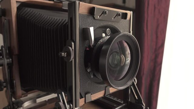 Vintage, wooden large format 4x5 tilt & shift camera focusing by moving lens.