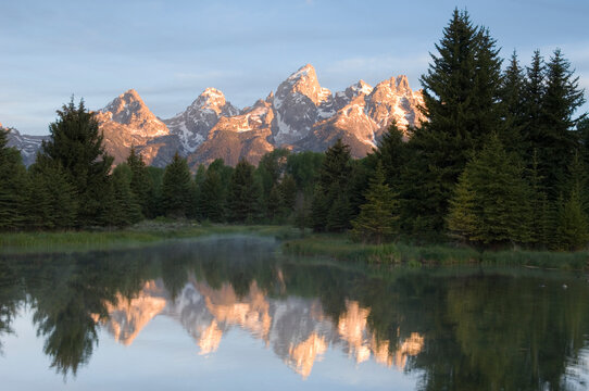 Sunrise on the Grand Teton and its reflection in Grand Teton National Park, Wyoming.