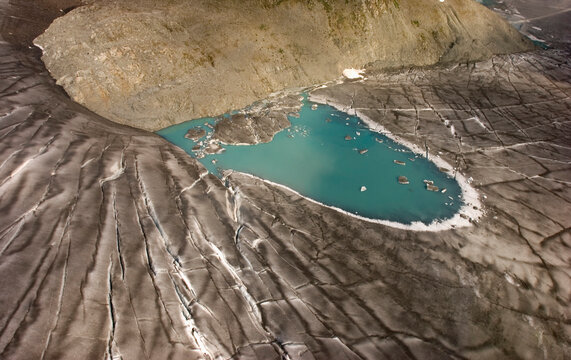 A turquoise supraglacial meltwater pond on top of the Brady Glacier, Glacier Bay National Park, Alaska.