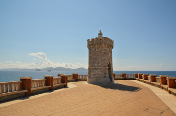 View of Piombino, piazza Bovio lighthouse and Elba Island. Maremma Tuscany Italy. On a bright sunny...