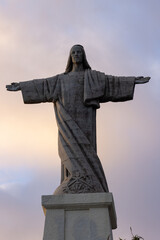Great photo of the Cristo Rei statue in Madeira on a beautiful evening with a red sky.