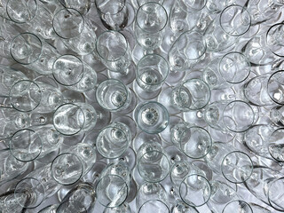 Overhead view of rows of empty champagne flute glasses on a table waiting to be filled. No people.