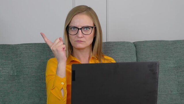 Bossy caution. Portrait of serious angry woman pointing her finger, showing warning gesture on camera, anxious to be careful. she shakes her finger threatening looking into camera.