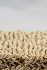 Dry instant ramen noodles on white background.