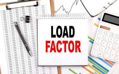 LOAD FACTOR text on notebook with chart, calculator and pen