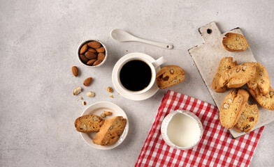 Homemade biscotti with almond and with espresoo coffee on a red napkin with cream, top vie , copy space