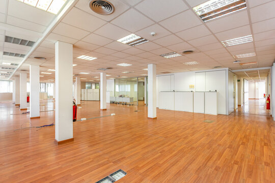 This abandoned open office is a reminder of a failed business, with empty space and no furniture. The once bustling environment now stands as a forgotten and neglected place.