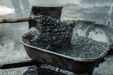 workers fixing potholes on the road