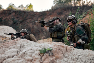 Fully Equipped Soldiers Wearing Camouflage Uniform Attacking Enemy, Rifles in Firing Position. Military Operation in Action, Squad On Fight, Pointing Rifle At Side, Concentrated.