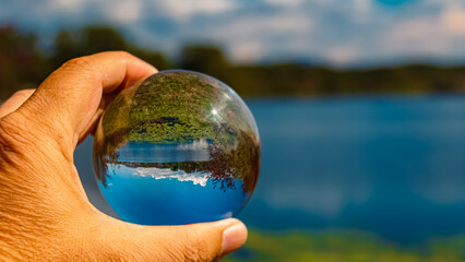 Crystal ball summer landscape shot at a pond near Plattling, Isar, Bavaria, Germany