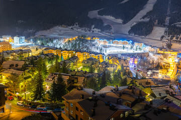 Long exposure, night photography of beautiful El Tarter town illuminated by street lights. Ski winter holidays in Andorra, Pyrenees - obrazy, fototapety, plakaty