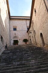 Old narrow alley with many stairs in Assisi, Umbria Italy
