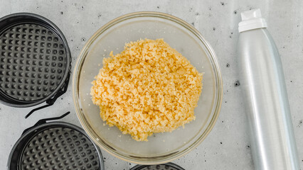 Cracker crust for cheesecake recipe. Mixing crushed crackers with melted butter. Homemade mini cheesecakes preparation process, close-up ingredients, flat lay