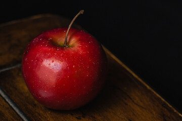 High angle close-up of wet apple on wooden table