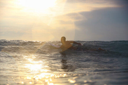 Surfer at sunset time