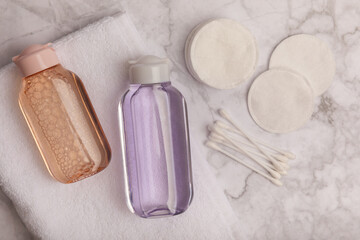 Micellar cleansing water and pads for removing makeup and cleansing the skin of sebium on a white marble table.Beauty concept. Flat lay.Copy the space text. Place to copy.