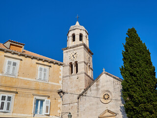 Fototapeta na wymiar Parish church of St Nicholas in a sunny summer day with a bright blue sky. Cavtat, a village in the Dubrovnik-Neretva County of Croatia. Europe