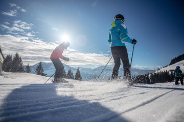 man and woman skiing and snowboarding in the mountains, ski resort