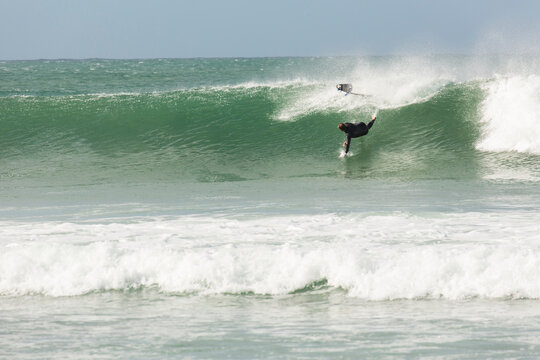 A Male Surfer Wipes Out On A Wave While Surfing In Jeffrey's Bay, South Africa
