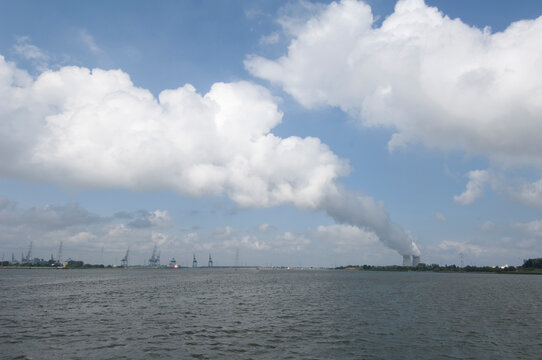 Industrial landscape with Doel nuclear power plant chimneys and steam on the Schelde river estuary, near Antwerp