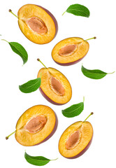 flying half of fresh plum fruits with green leaves isolated on white background. clipping path