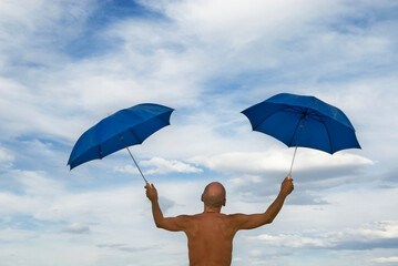 An unidentified burner twirls two umbrellas at the Burning Man Festival in Black Rock City, Nevada.