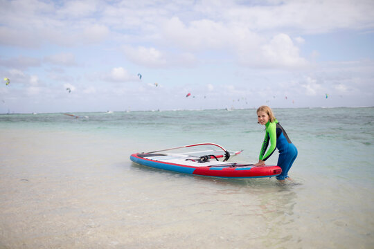 Girl with surfboard in ocean