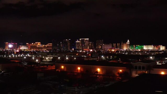 Wide rising aerial shot of the south and central Las Vegas Strip at night. 4K