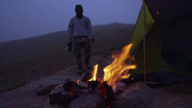 Man Coming Towards His Bonfire And Tent, Camping Out In Nature, Obrajillo, Peru