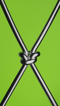 Dynamic steel rope on a green background transforming to a reef knot.