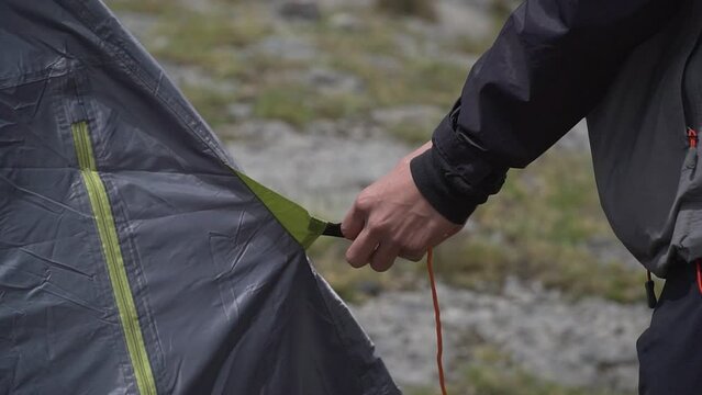 Camper Ties Rope Of His Tent Setting Up For Camping In Rural Area, Obrajillo, Peru