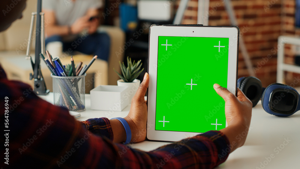 Wall mural young student using greenscreen template on digital tablet, analyzing isolated copyspace display on 