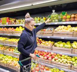 Woman buying fruits and vegetables at the market