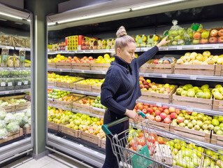 Woman buying fruits and vegetables at the market