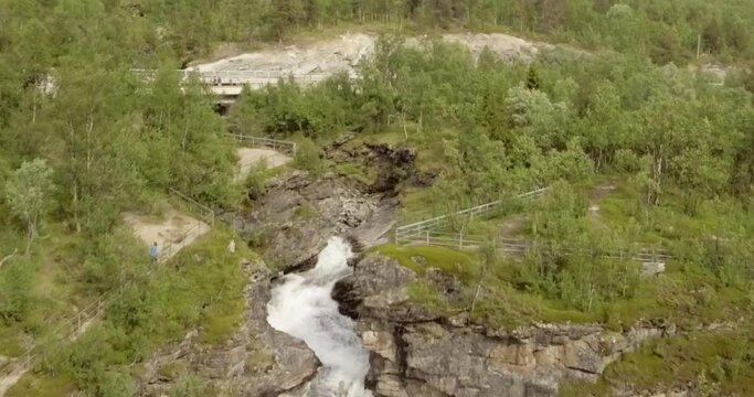 Aerial view of  Rovijokkfossen waterfall on the E8 Nordlysveien road in summer, Storfjord, Troms og Finnmark, Norway.