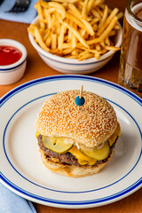 Hamburger. Bacon Cheeseburger. Classic traditional American bar, restaurant entree. Beef hamburger with Swiss and cheddar cheeses served with lettuce, tomato, onion and hand cut french fries. 