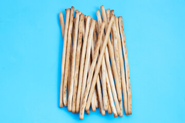 Bread sticks on blue background