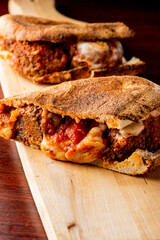 Meatball Sandwich. Meatball  submarine sandwich. Meatballs, tomato marinara sauce, cheese on Italian bread. Provolone, mozzarella, garlic, green peppers and butter. Classic Italian-American deli.