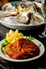 Crab cake. Crab cake served with spicy rémoulade sauce on top of a mixed green salad. Jumbo crab meat mixed with garlic, onions, spices and fried in butter. Classic American restaurant appetizer.