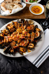Seafood Pasta with clams. Pasta with clams, seafood, Parmesan cheese, spinach, and Italian parsley. Classic American or Italian restaurant favorite. Homemade pasta, tomato sauce, meats and cheeses.