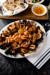 Seafood Pasta with clams. Pasta with clams, seafood, Parmesan cheese, spinach, and Italian parsley. Classic American or Italian restaurant favorite. Homemade pasta, tomato sauce, meats and cheeses.