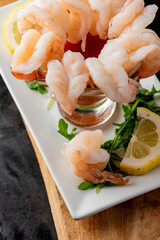 Shrimp cocktail. Seafood platter or shrimp cocktail. Jumbo shrimp, oysters, clams, crab claws served on ice garnished with lemon wedges. Classic American party appetizer.