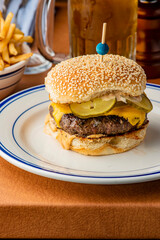 Hamburger. Bacon Cheeseburger. Classic traditional American bar, restaurant entree. Beef hamburger with Swiss and cheddar cheeses served with lettuce, tomato, onion and hand cut french fries. 