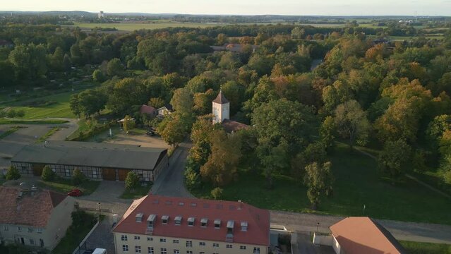 Village church in park. Breathtaking aerial view flight wide orbit overview drone
Paretz Brandenburg Havelland Germany summer evening 2022. High Quality 4k Cinematic footage