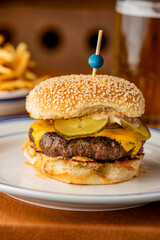 Hamburger. Bacon Cheeseburger. Classic traditional American bar, restaurant entree. Beef hamburger with Swiss and cheddar cheeses served with lettuce, tomato, onion and hand cut french fries. 