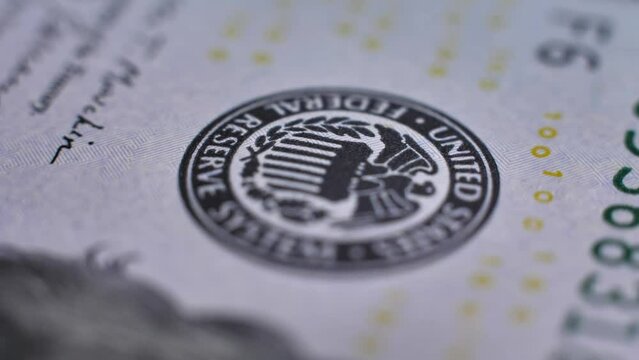 Macro video. Close-up of US 100 dollar bill. Rotation of 100 dollar. Details and texture of American cash. Accent On US Federal Reserve System logo on USA banknote. Finance, business and banking.